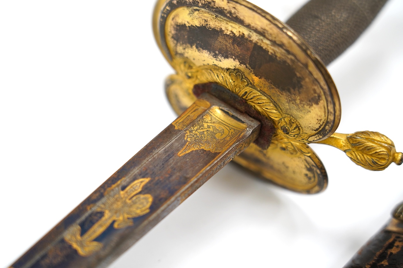 A 1796 pattern infantry officer's sword, blued and gilt blade, etched with crowned GR and Royal Arms, regulation gilt brass hilt, in its leather scabbard with brass mounts, locket signed S. Brunn, 81.5cm. Condition - goo